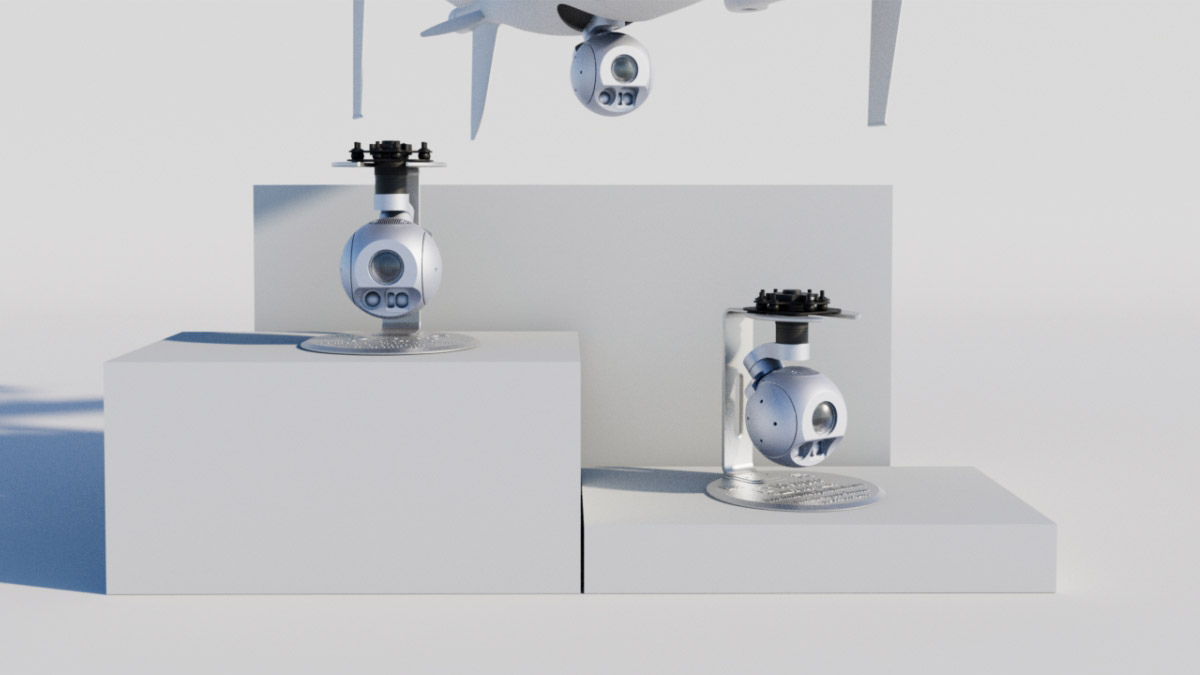 Manufacturer display of A40TR Pro gimbals and an illustrative under-aircraft mounting position